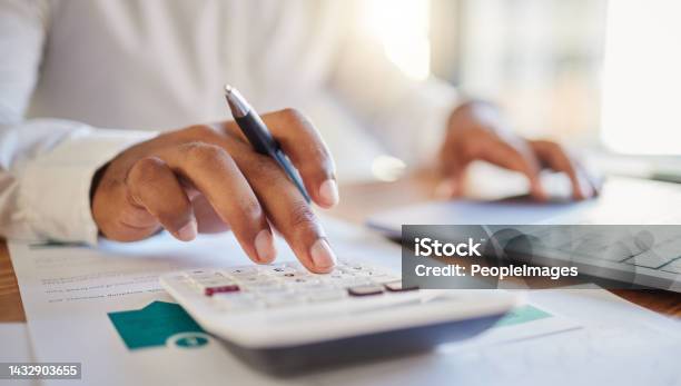 Finance Accounting And Fintech A Man On A Computer And Calculator Working Out His Business Budget Strategy Businessman At His Office Desk Laptop Money Management And Financial Investment Online Stock Photo - Download Image Now