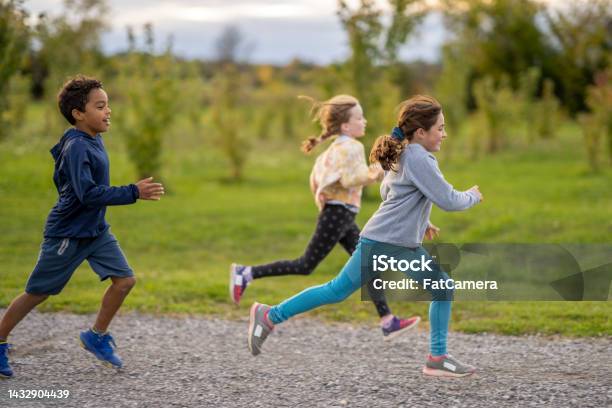 Children Running A Race Stock Photo - Download Image Now - Child, Lifestyles, Vitality