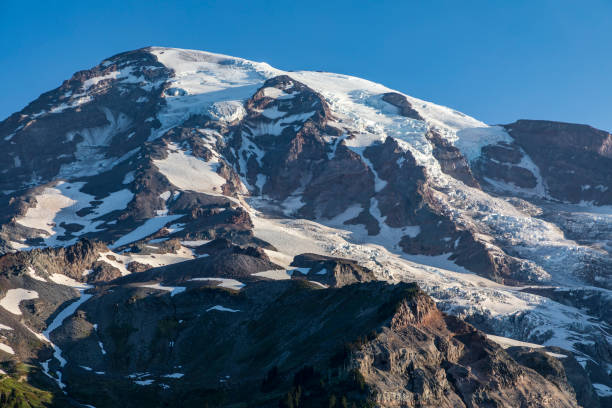 istock snow capped Mt.Rainier under  a clear summer sunny blue sky 1432905094