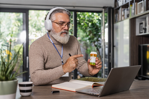 Family doctor consulting his patients online in a virtual appointment