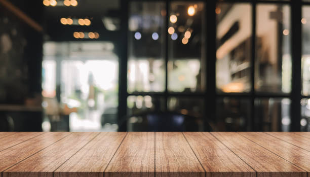 istock Empty wooden table top with lights bokeh on blur restaurant background. 1432911295