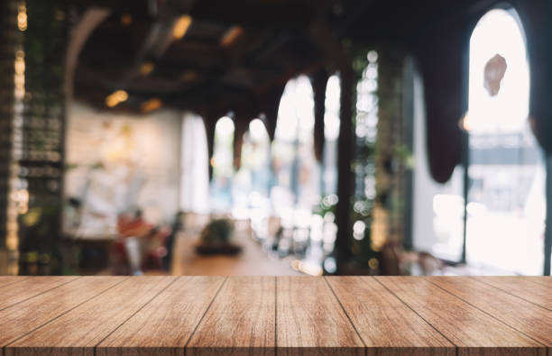 istock Empty wooden table top with lights bokeh on blur restaurant background. 1432911297