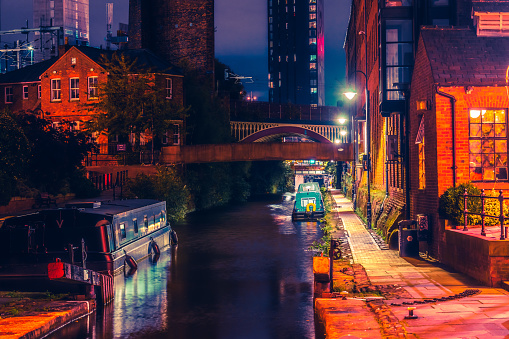 Red Historic Bridge running over the Castlefield canal in Manchester at night