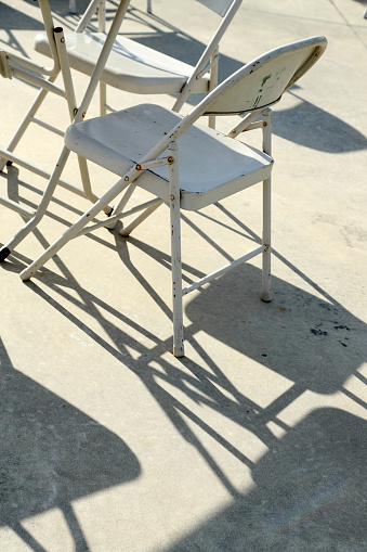 The shadow of many chair showing the abstract line on the floor.