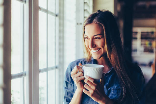 istock Relaxed woman at home drinking coffee 1432919321