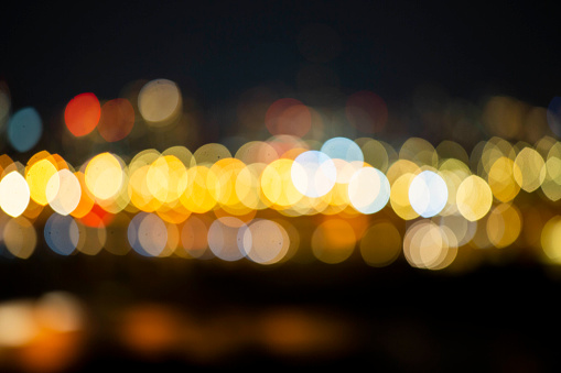 Night bokeh light, blur background of cityscape, blue color toned, abstract.