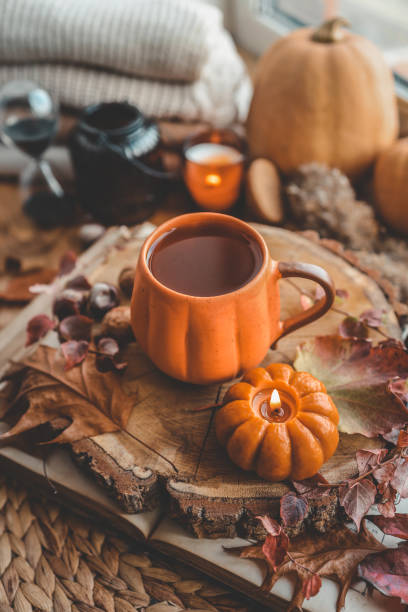 istock Autumn cozy decor, cup of tea, candles, pumpkins 1432920752