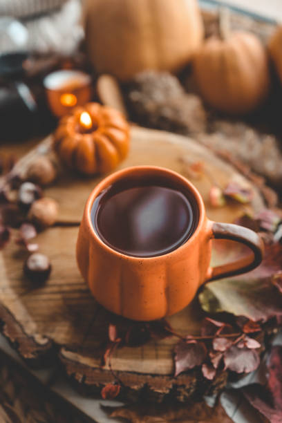 istock Autumn cozy decor, cup of tea, candles, pumpkins 1432920763