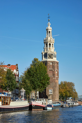 The Montelbaanstoren old city tower at Oudeschans canal in Amsterdam, The Netherlands