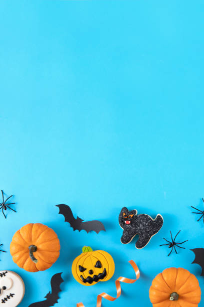 istock Halloween Decorations Pumpkins Candies Bats on Blue Background 1432924318