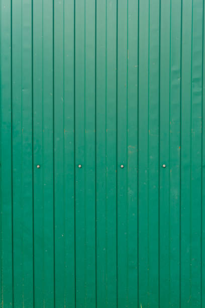 istock Green metal surface. Texture. Fence with rivets close-up 1432925159