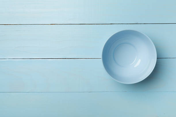 istock Empty round plate on wooden background, top view 1432926309