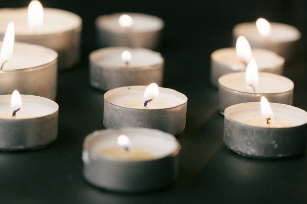 istock Candles Burning at Night. White Candles Burning in the Dark 1432927785