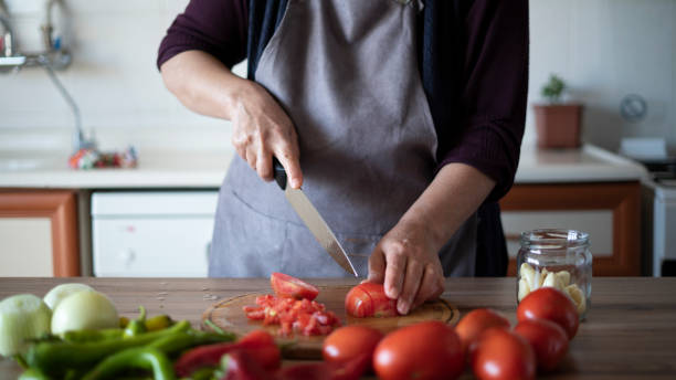 istock Close-up woman chopping vegetables 1432927842