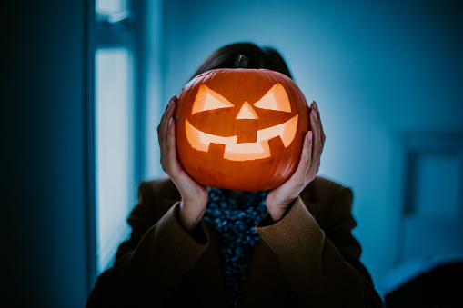 Woman holding Halloween pumpkin