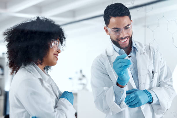 istock Two young science experts conducting a research experiment in the lab together. Two scientists collaborating, brainstorming during a meeting. Medical colleagues planning and writing ideas on a board 1432931178