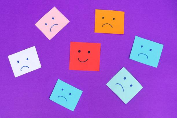 istock Happy Face amid Sad and Depressed Faces Isolated on Blue Background, Happiness and Positive Conceptual Photo 1432931248