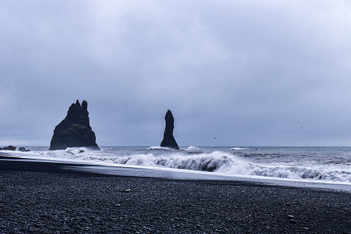 The mysterious pillars and rough sea of Reynisfjara Black Sand Beach on Iceland