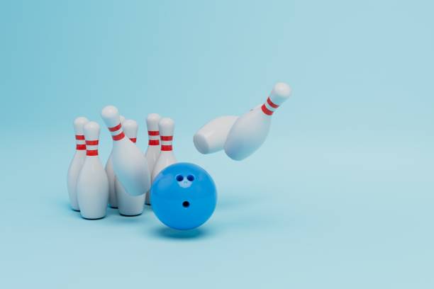 istock flying and standing skittles and a blue bowling ball on a blue background. copy paste, copy space. 3D render 1432932589