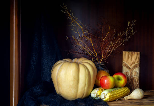 Halloween concept. Still Life with pumpkin, apples and corn on wooden background close-up.