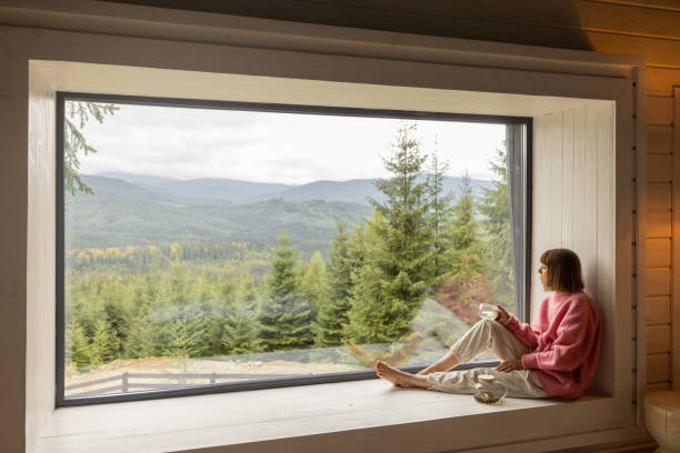 istock Woman rests in house with scenic view on mountains 1432937210
