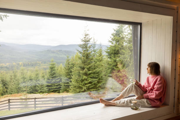 istock Woman rests in house with scenic view on mountains 1432937321