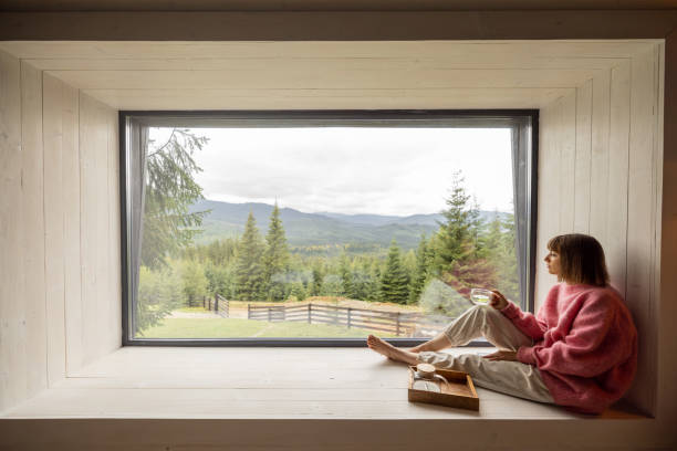 istock Woman rests in house with scenic view on mountains 1432937395