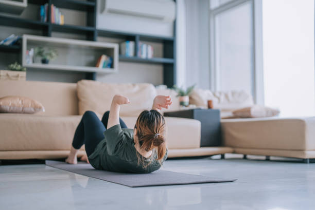 istock Chinese woman with disability deformed arm sit up home workout 1432938137