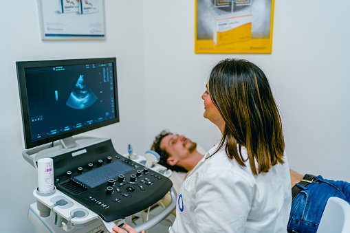 Young man having an ultrasound examination of the heart in the clinic