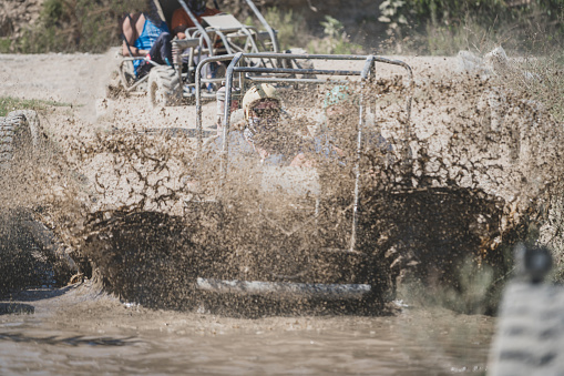 quad safari bike sliding on muddy  water