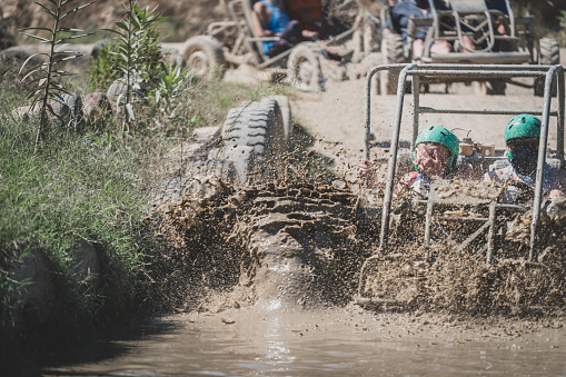 quad safari bike sliding on muddy  water