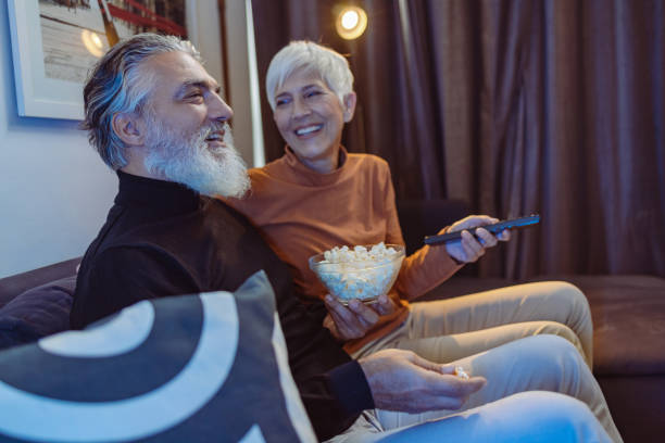 istock Senior couple watching TV at night 1432945920