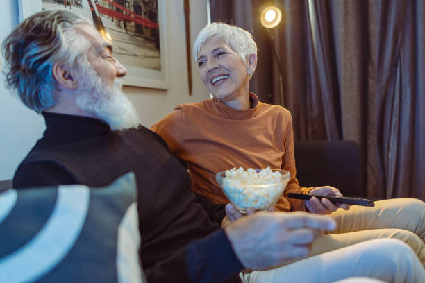 istock Senior couple watching TV at night 1432945923
