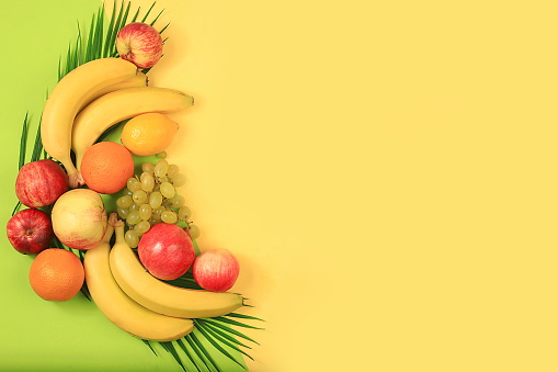 Detox diet and weight loss concept. summer tropical fruits on a yellow table, top view, healthy and natural food and a source of vitamin C in the cold season, banner for a store, selective focus, space for text