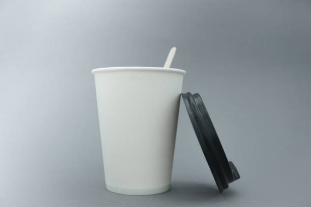 istock White paper cup. Place for text. A paper cup on a gray background. 1432947754