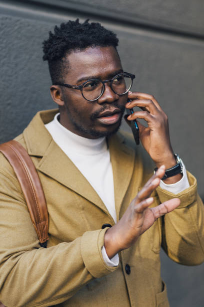 istock Young black businessman having a serious conversation over the phone 1432948914