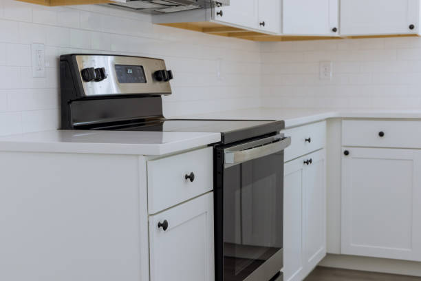 istock Installing kitchen appliances in a new home as well kitchen cabinets in a new home 1432952643