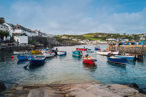 Coverack, UK - Oct 3 2022.  Small boats and fishermen in the Coverack harbour. A coastal village and fishing port in Cornwall, England. It lies on the east side of the Lizard peninsula