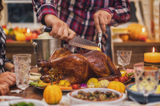 istock Father carving traditional stuffed Thanksgiving turkey 1432953902