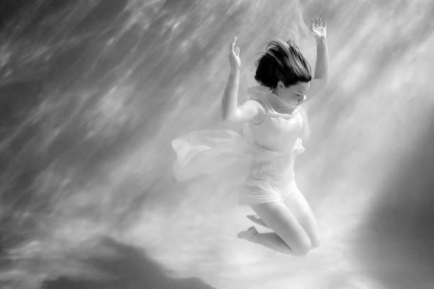 imagem conceitual de uma mulher debaixo d'água - black and white people imagination underwater - fotografias e filmes do acervo