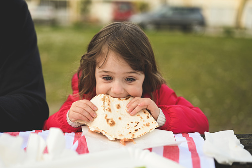 hungry,italian food,italy,lunch,meal,outdoors,patio,piadina,picnic,picnic table,pita bread