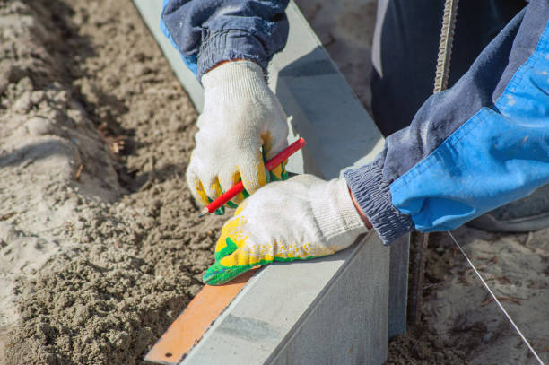 istock A worker measures a concrete block with a ruler, close-up. 1432966260