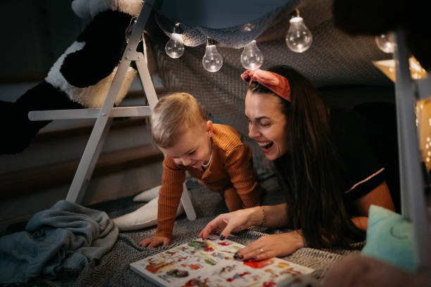 istock Happy mother and son playing at home in tent 1432970297