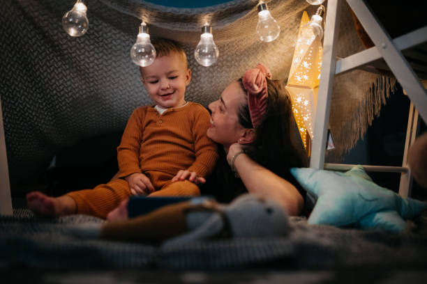 istock Happy boy and Mom playing at home in a tent 1432970300