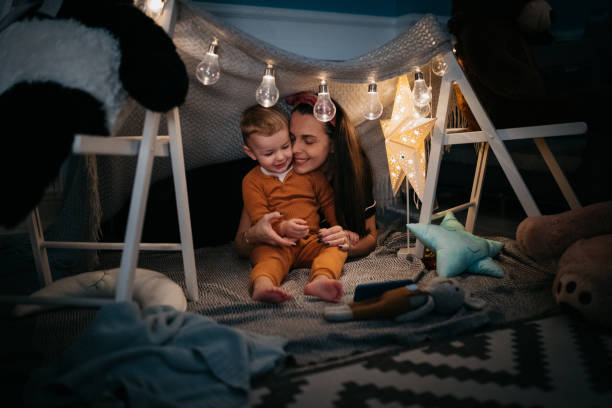 istock Happy boy and Mom playing at home in a tent 1432970355
