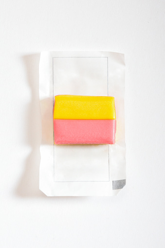 Open package bubble gum, multi colored chewing gum on the white background