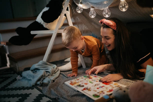 istock Happy mother and son playing at home in tent 1432970951