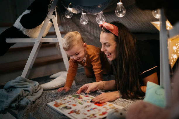 istock Happy mother and son playing at home in tent 1432971059