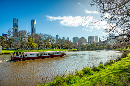 River Cruise Boat and Downtown Melbourne, Victoria, Australia on sunny day.