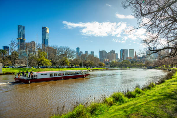 Melbourne Australia Yarra River Cruise Tourboat River Cruise Boat and Downtown Melbourne, Victoria, Australia on sunny day. yarra river stock pictures, royalty-free photos & images